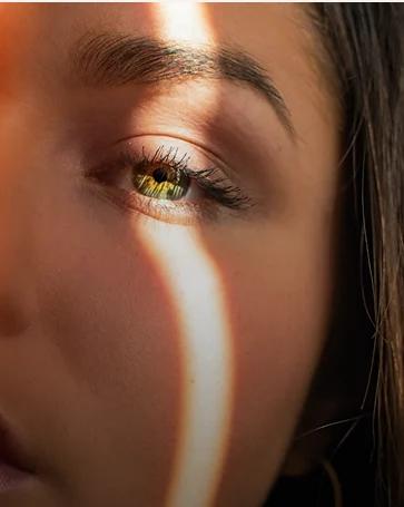 Portrait with dramatic golden light streak across face
