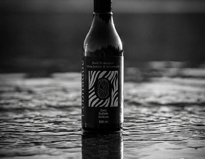 Lébnadeu shampoo bottle standing in rippling water